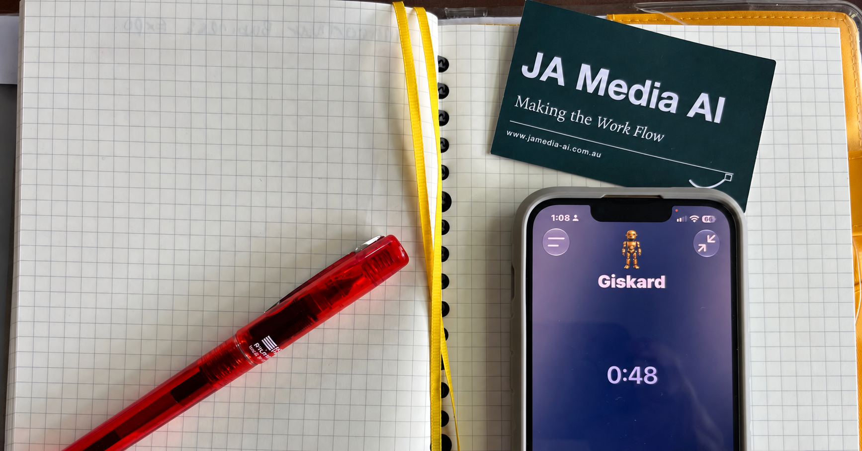 Notebook, JA Media AI card and phone showing Giskard